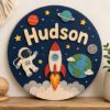Picture of Personalized Space Name Sign, Custom Rocket Door Hanger, Astronaut Kids Room Decor, Outer Space Nursery Wall Art, Round Wood Baby Gift