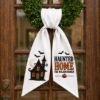 Picture of Personalized Haunted House Wreath Sash Bow, Custom Family Name Halloween Door Bow, Embroidered Haunted Home Wreath Sash, Spooky Door Decor