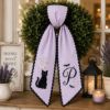 Picture of Personalized Black Cat Halloween Wreath Sash, Custom Monogram Door Bow, Embroidered Spooky Front Door Decor, Purple Halloween Ribbon