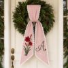Picture of Personalized Christmas Sash, Embroidered Amaryllis Monogram Sash, Red Stripe Holiday Accessory, Custom Initial Christmas Gift Sash Wreath