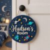 Picture of Personalized Space Name Sign, Custom Kids Room Door Hanger, Astronaut Rocket Nursery Wall Decor, Boys Bedroom Gift, Round Wood Sign Boy